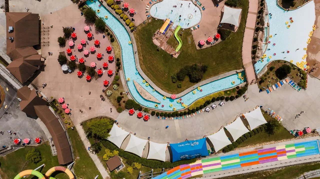 Family water park lazy river in Dubai with children floating in shallow water