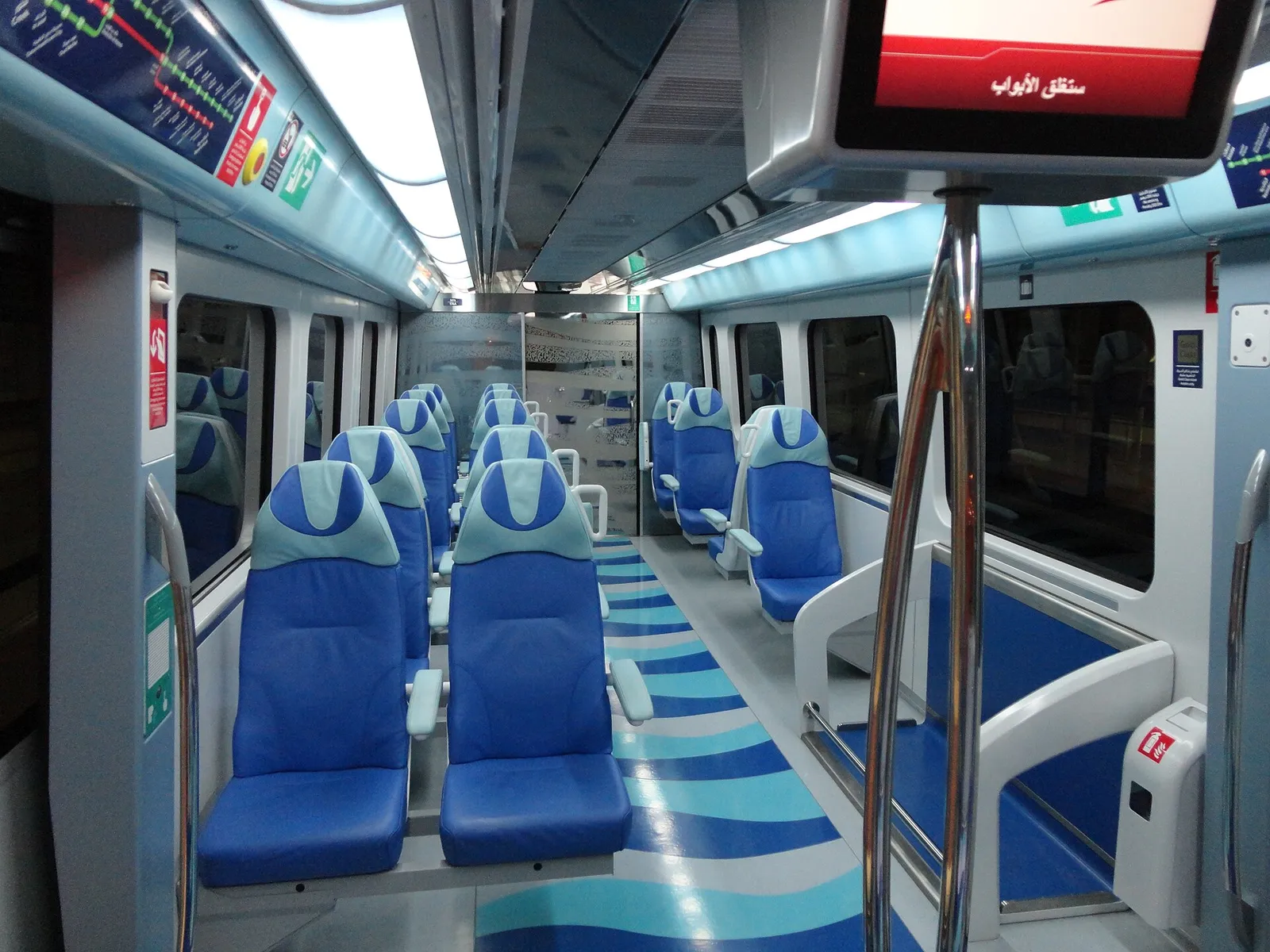 The interior of a Dubai Metro carriage with seats and windows, United Arab Emirates