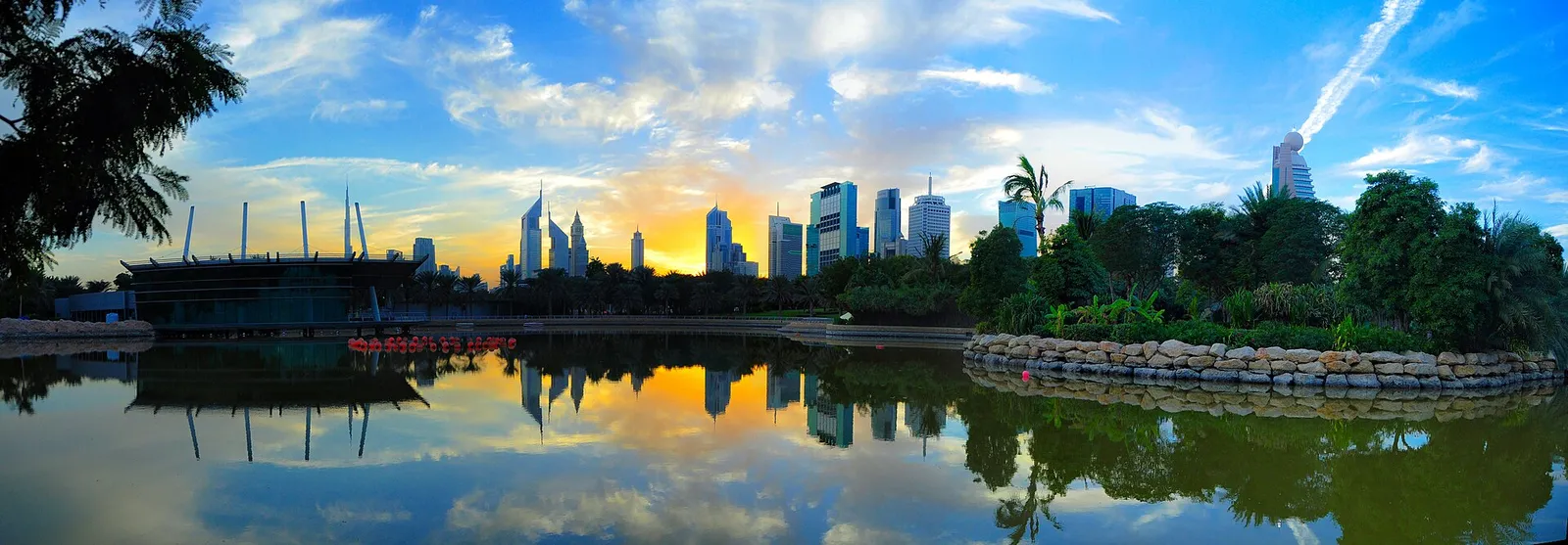 The skyline of Dubai reflected in water at sunset, United Arab Emirates