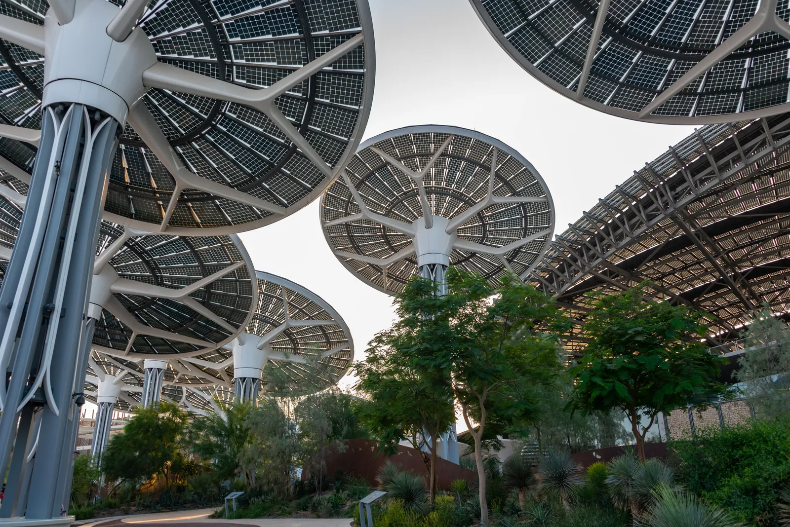Visitors walking through landscaped gardens at Expo City Dubai