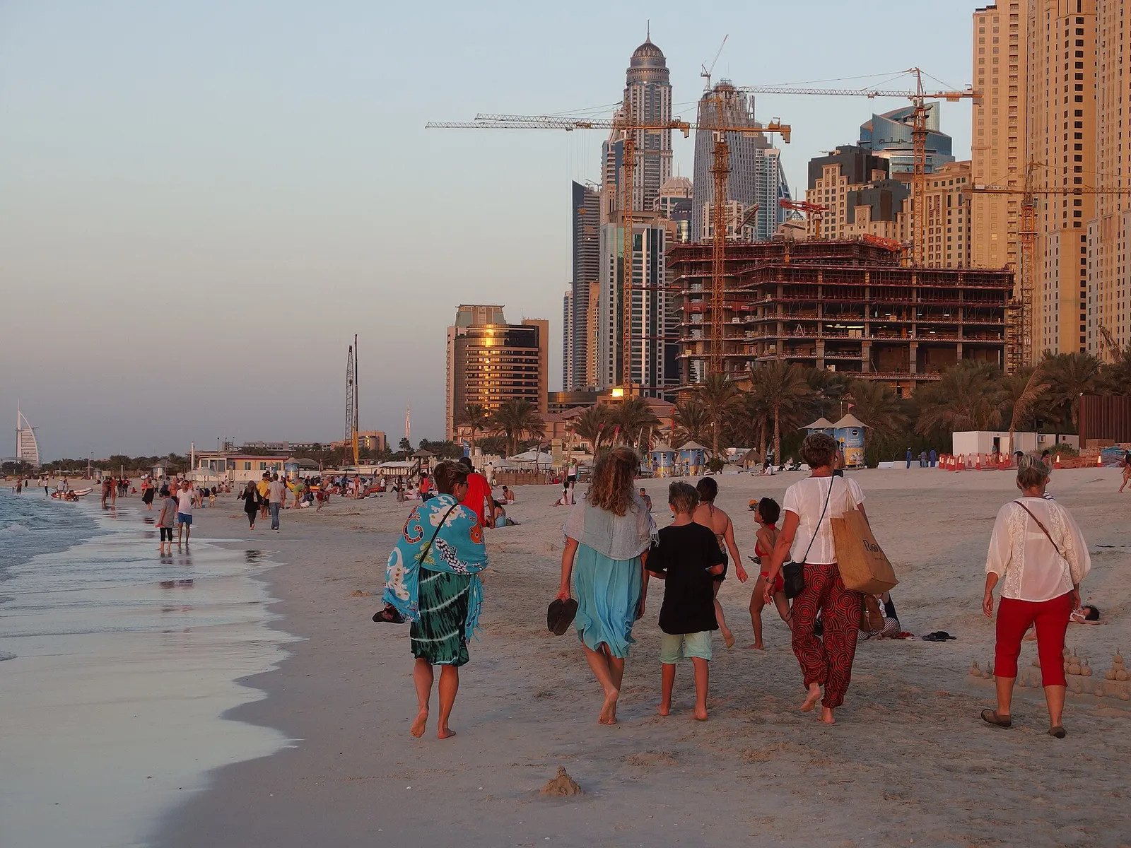 People walking on the beach at Jumeirah Beach Residence in Dubai, United Arab Emirates
