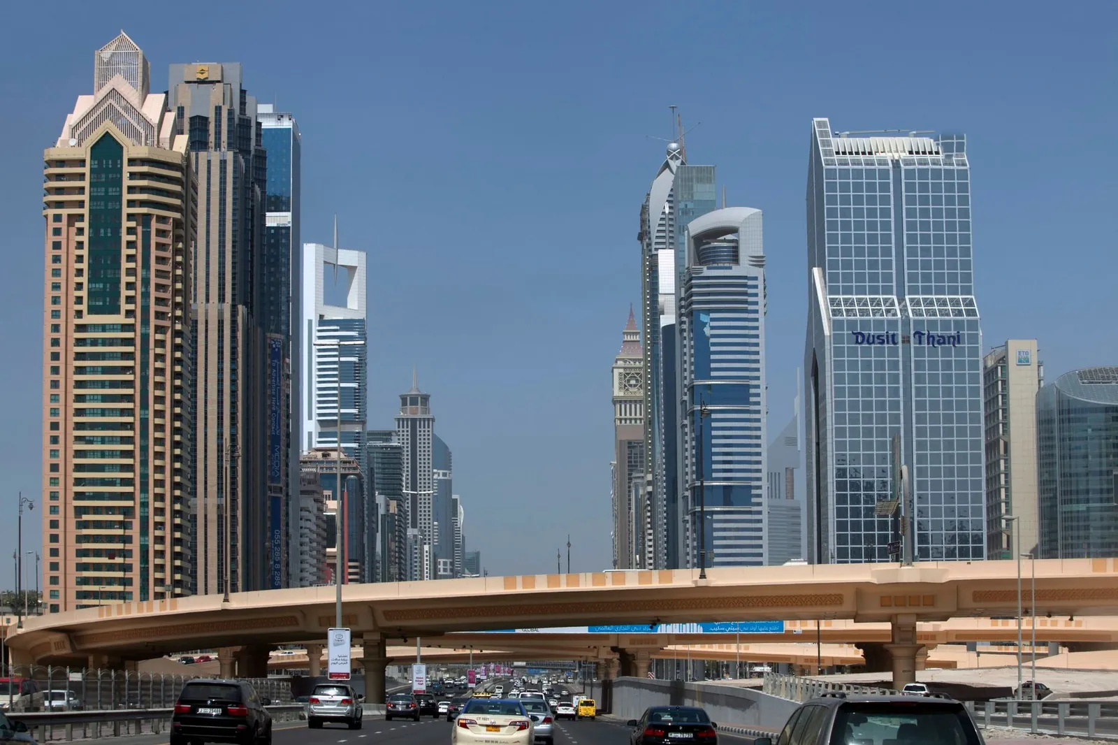 Skyscrapers lining Sheikh Zayed Road in Dubai under a clear blue sky