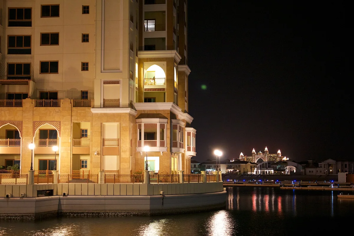 A lit waterfront promenade at night