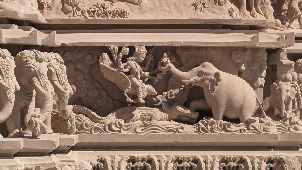 A carved stone relief with an elephant and figures