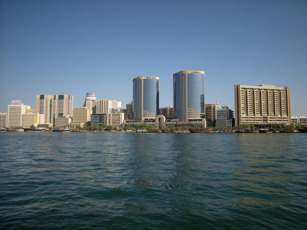 Buildings on a creek bank seen from the far side