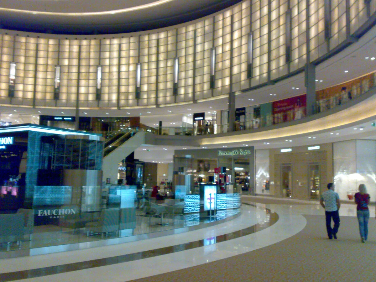 Curved mall levels with lit shopfronts