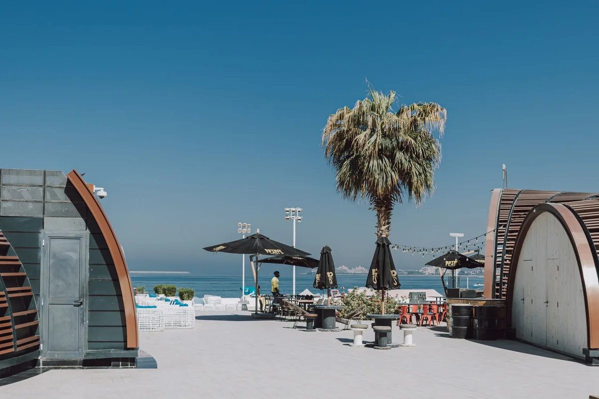 A beachside cafe with shaded seating pods
