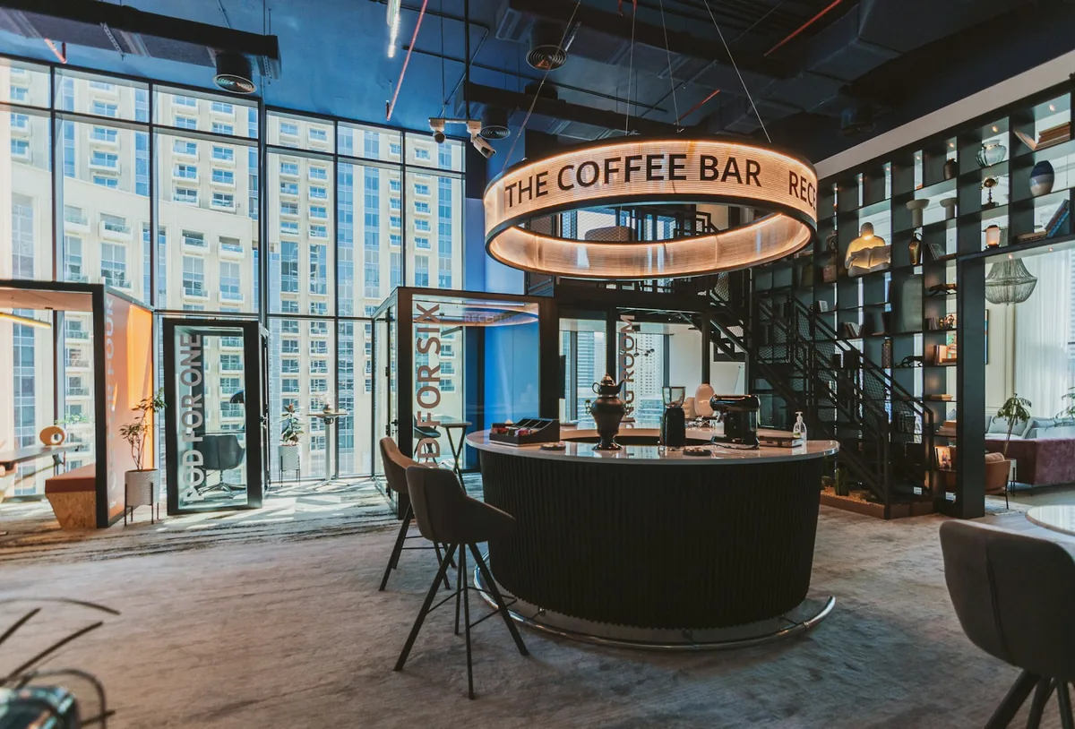 A cafe counter in a lobby with tall windows