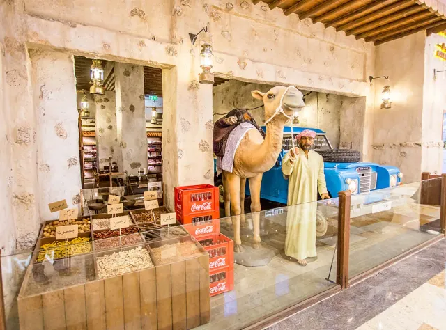 A heritage display inside the restaurant with a spice stall, a camel figure and a vintage car