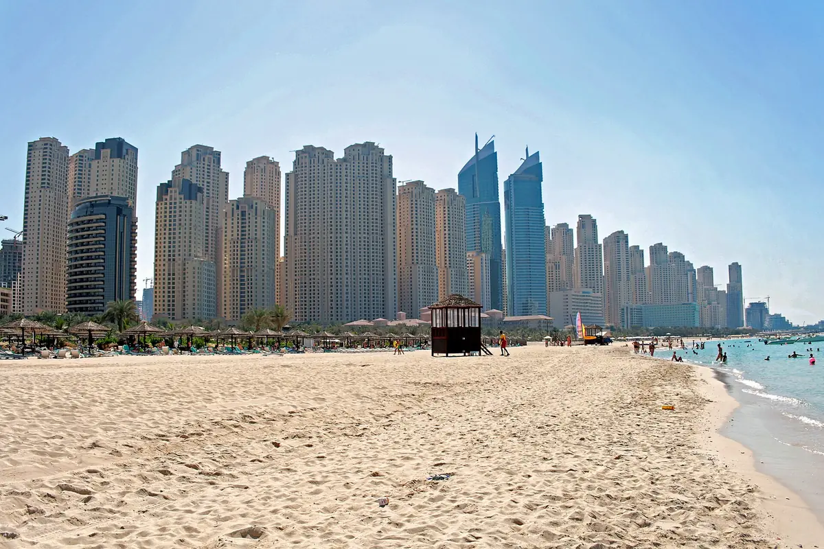 A white sand beach in front of high rises