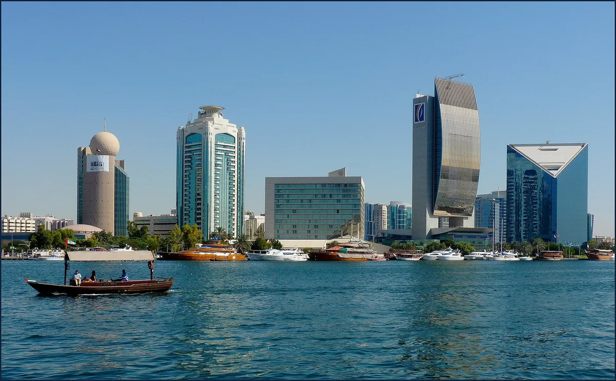Traditional boats on a waterway in front of towers