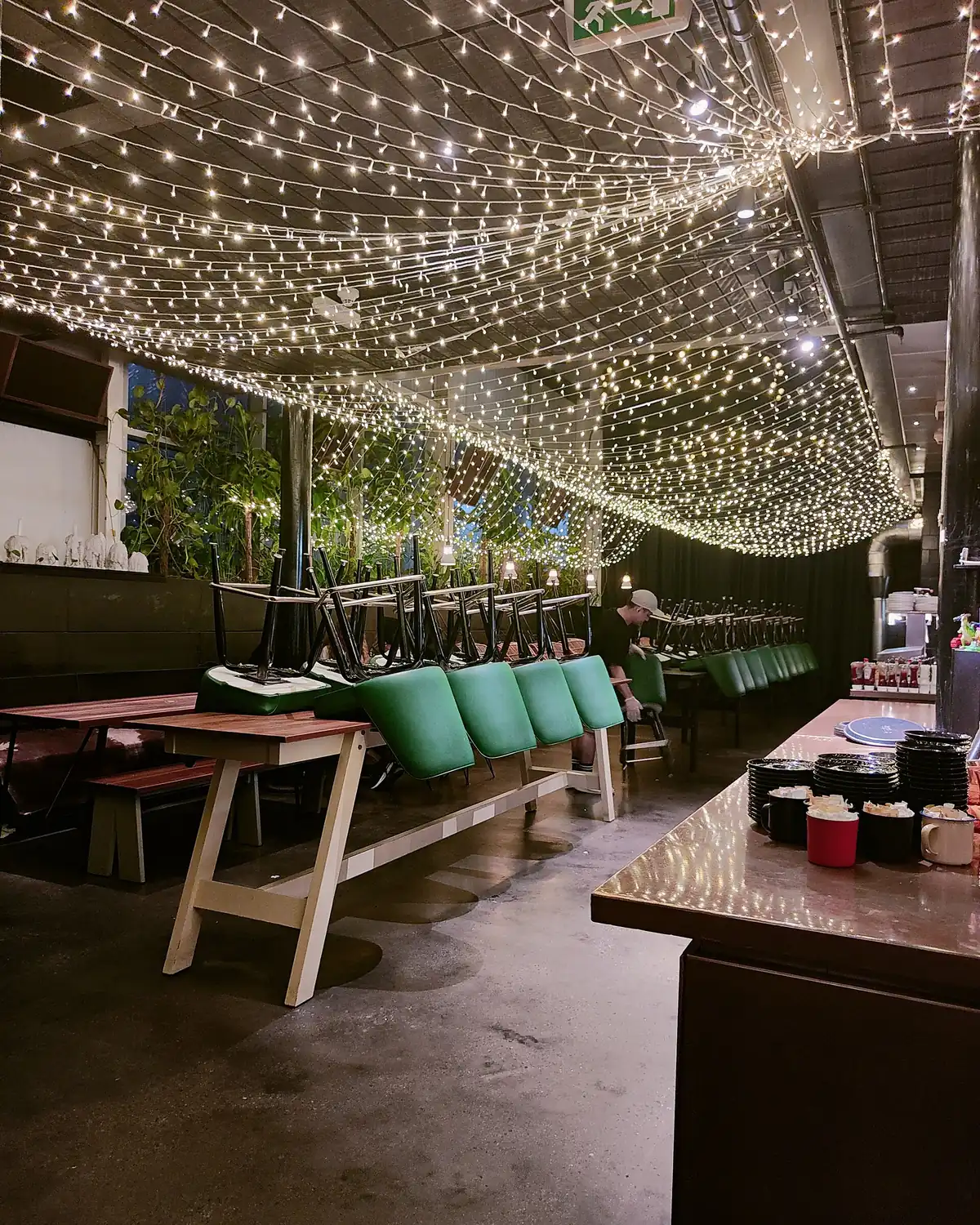 A warehouse turned venue strung with lights