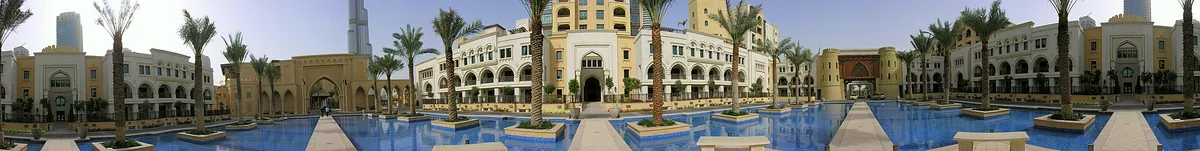 A plaza with arcades and palms in the old town