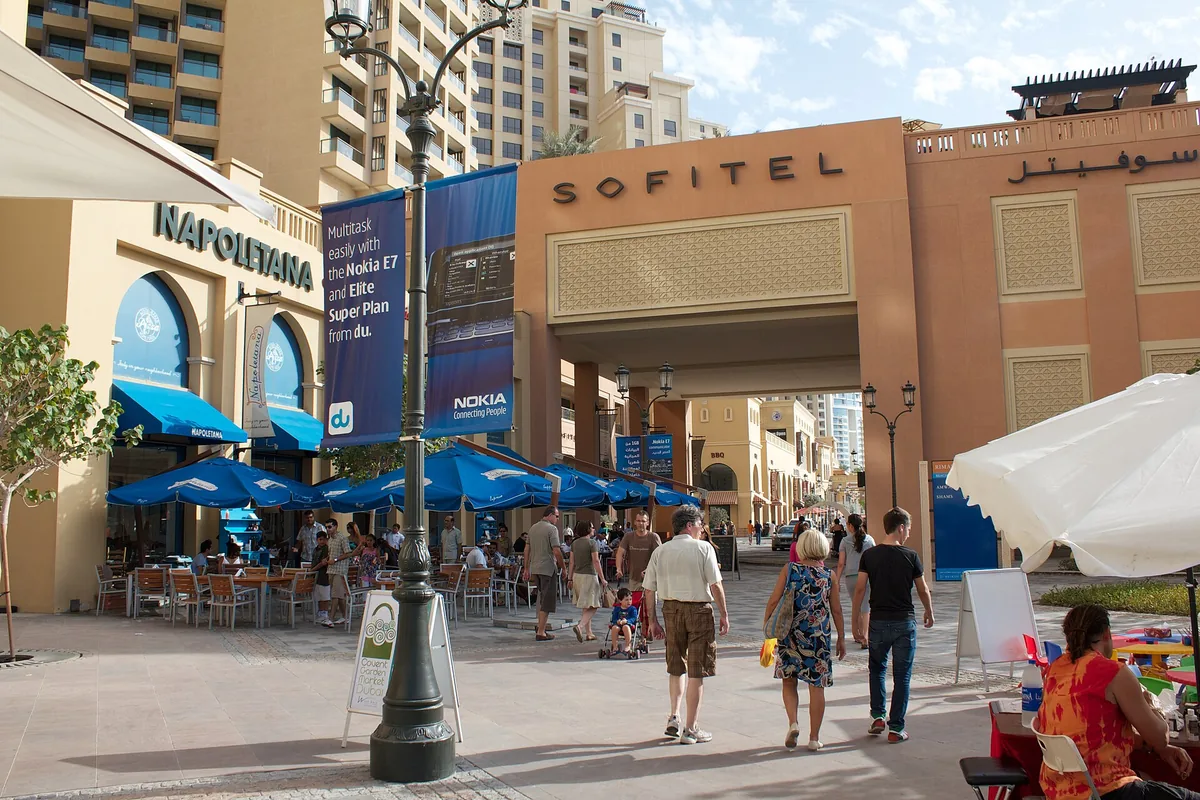 A promenade with parasols and cafes near the shore