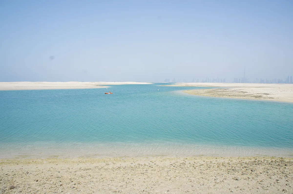 Shallow turquoise water beside a sandbar