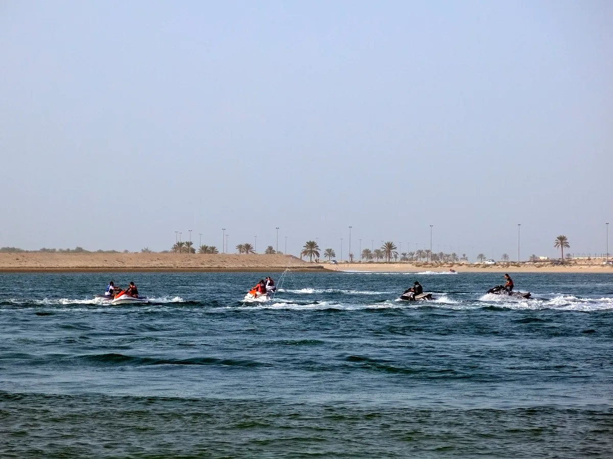 Jet skis on the water off the shoreline